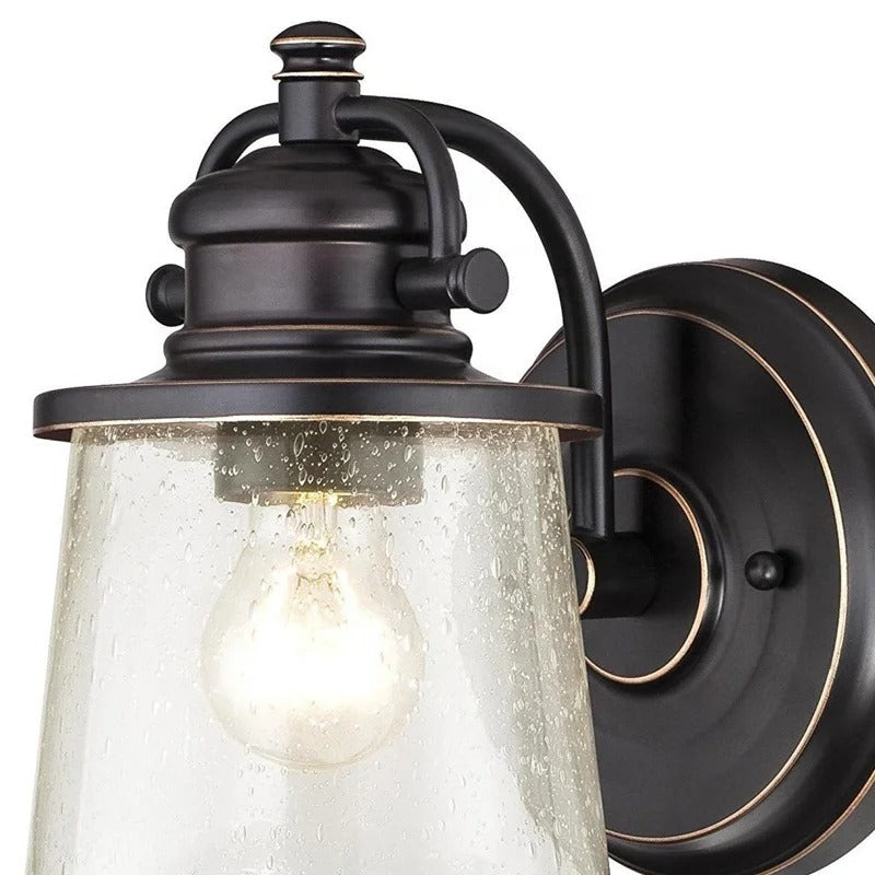 Brązowa lampa ścienna z przezroczystym kloszem z nasionkowego szkła