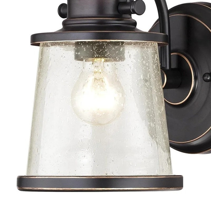 Brązowa lampa ścienna z przezroczystym kloszem z nasionkowego szkła